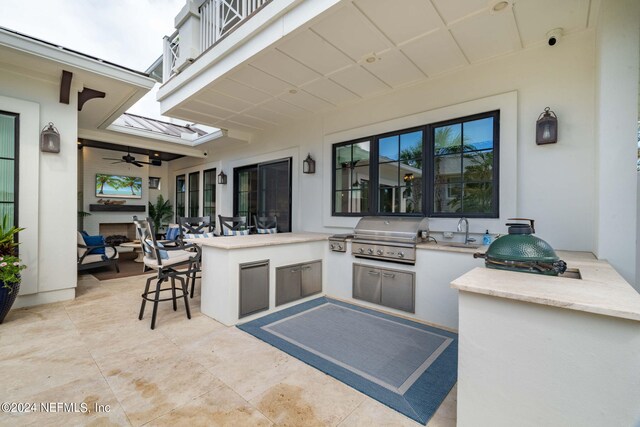 view of patio with a balcony, an outdoor kitchen, ceiling fan, and a grill