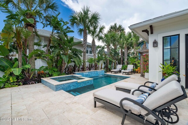 view of swimming pool with a patio area and an in ground hot tub