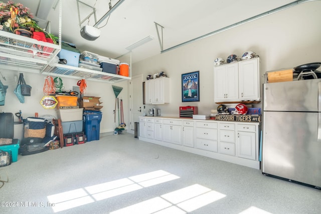 garage with stainless steel refrigerator