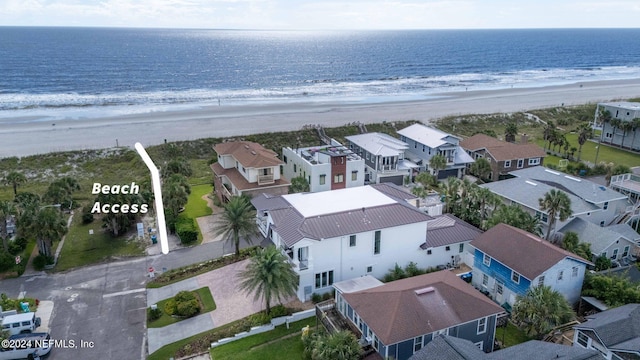 birds eye view of property with a beach view and a water view