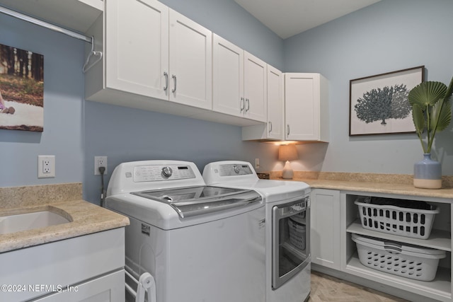 laundry room featuring cabinets and washer and dryer