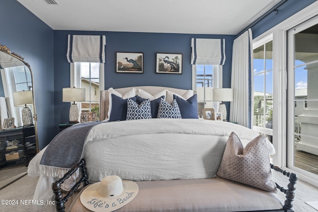 carpeted bedroom with multiple windows