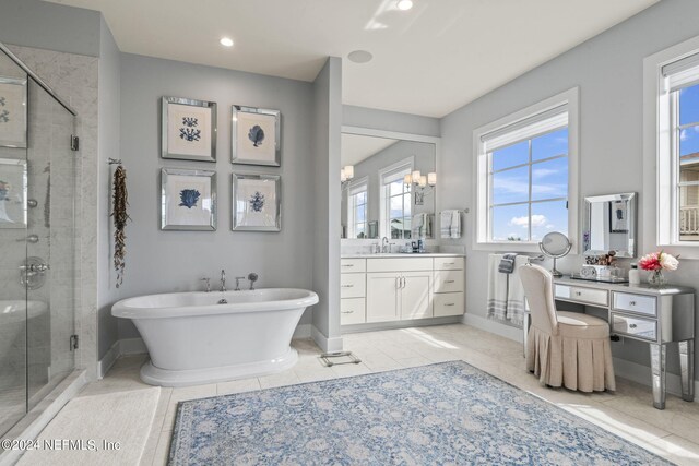 bathroom with vanity, independent shower and bath, and tile patterned floors