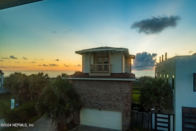 exterior space featuring a garage and a water view