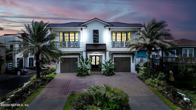 view of front facade with a garage and a balcony