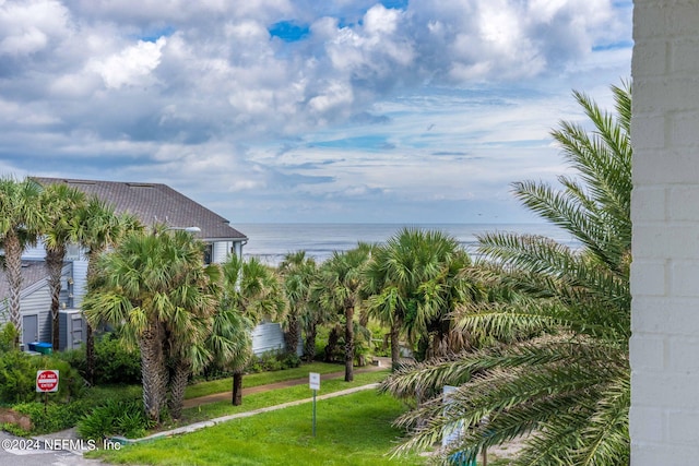 view of home's community featuring a water view and a yard