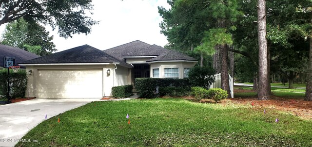 view of front facade with a front lawn and a garage