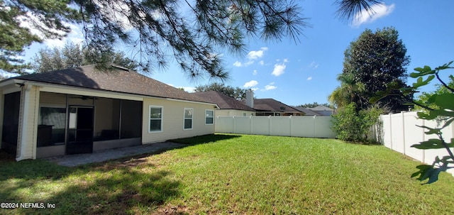 view of yard featuring a sunroom