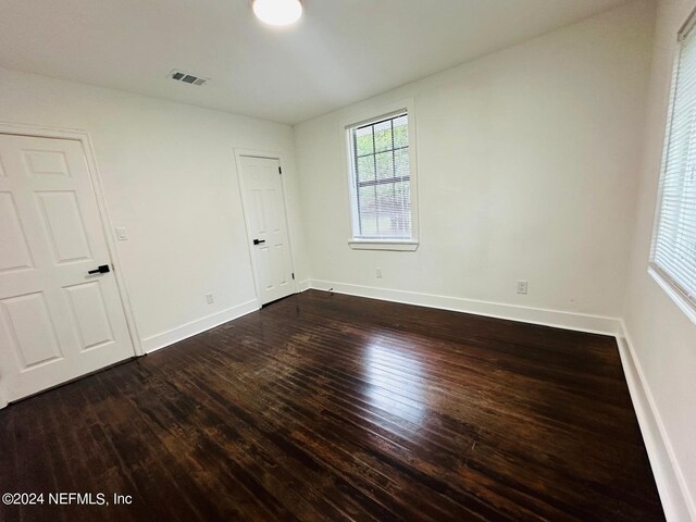 empty room with dark hardwood / wood-style floors