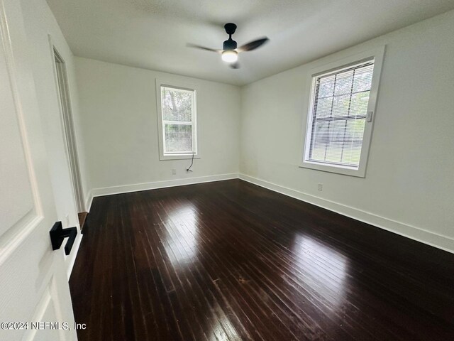 spare room with ceiling fan, plenty of natural light, and hardwood / wood-style flooring