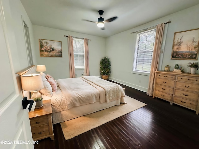 bedroom featuring multiple windows, ceiling fan, and dark wood-type flooring