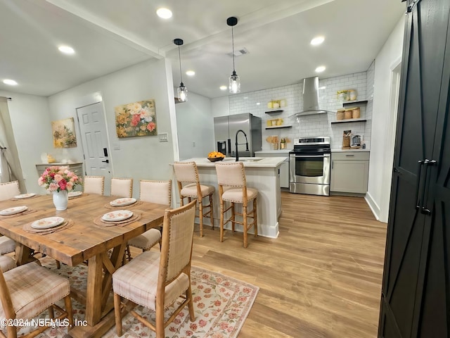 dining area featuring light hardwood / wood-style flooring and sink