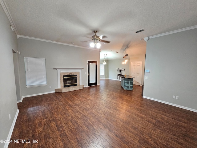 unfurnished living room with a textured ceiling, dark wood-type flooring, a premium fireplace, and ornamental molding