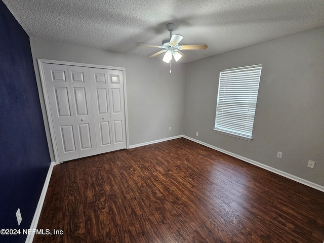 unfurnished bedroom with ceiling fan, a textured ceiling, and wood-type flooring