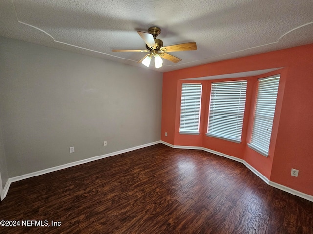 empty room with hardwood / wood-style flooring, a textured ceiling, and ceiling fan