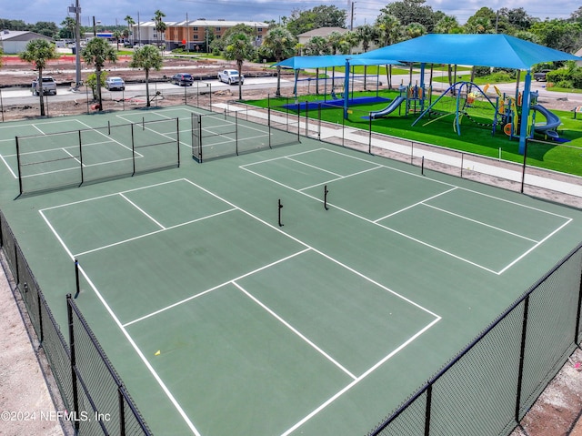 view of sport court featuring fence and playground community