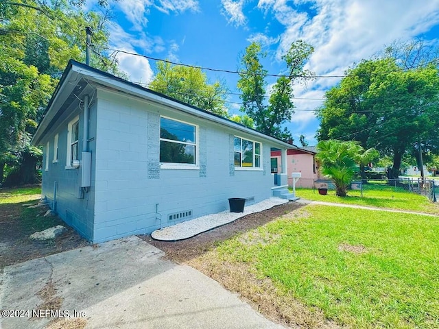 view of side of home featuring a yard