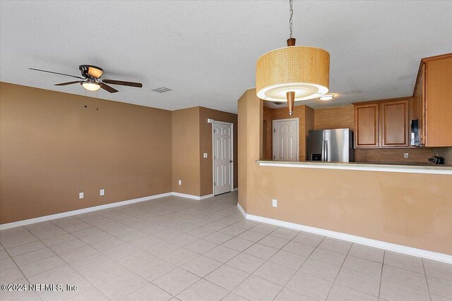 kitchen with light tile patterned floors, decorative light fixtures, decorative backsplash, ceiling fan, and stainless steel fridge with ice dispenser