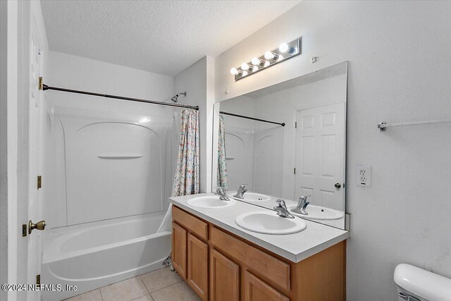 full bathroom with toilet, vanity, tile patterned floors, a textured ceiling, and shower / bathtub combination with curtain