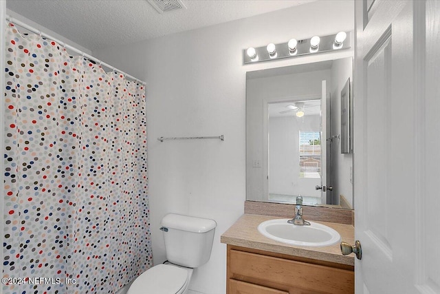 full bath with visible vents, toilet, a shower with curtain, a textured ceiling, and vanity