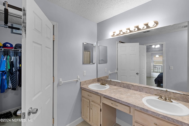 bathroom with vanity and a textured ceiling