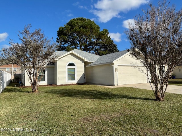 single story home featuring a front lawn, fence, roof with shingles, a garage, and driveway