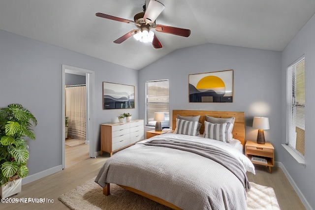 bedroom with light wood-type flooring, baseboards, a ceiling fan, and lofted ceiling