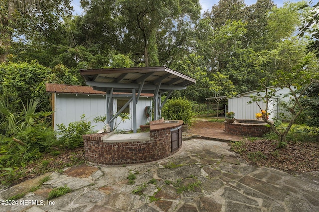 view of patio / terrace with a shed