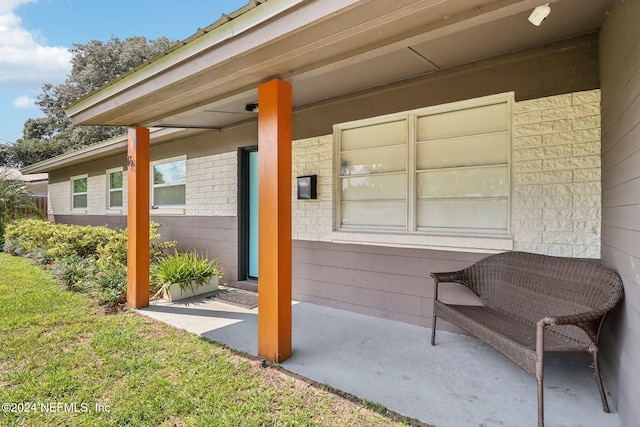 view of exterior entry featuring a patio