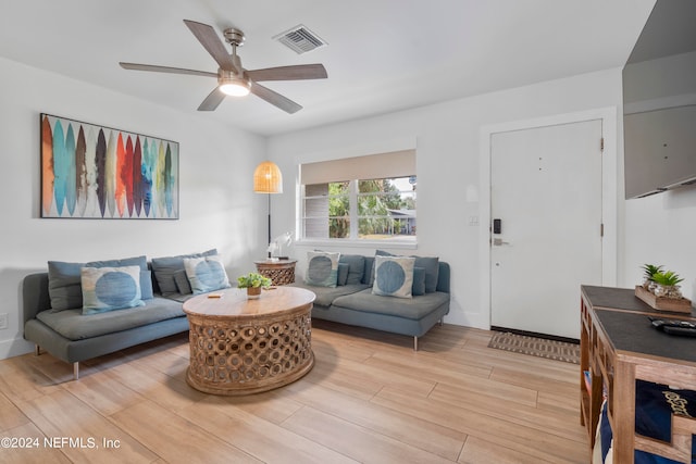 living room with ceiling fan and light wood-type flooring