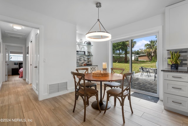 dining space with light hardwood / wood-style flooring