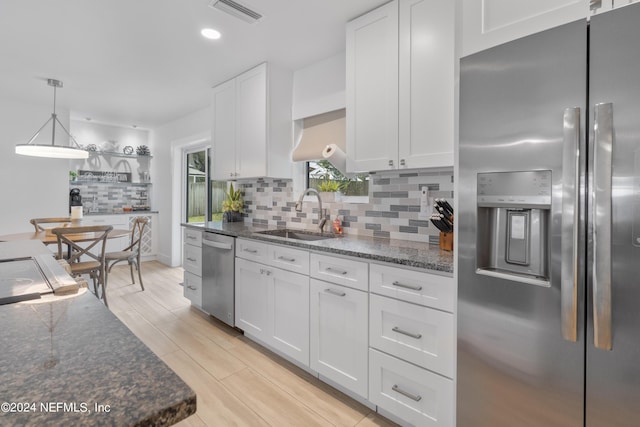 kitchen featuring visible vents, a sink, backsplash, appliances with stainless steel finishes, and white cabinets