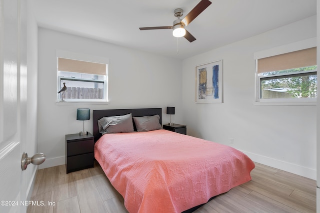 bedroom with ceiling fan and light hardwood / wood-style floors