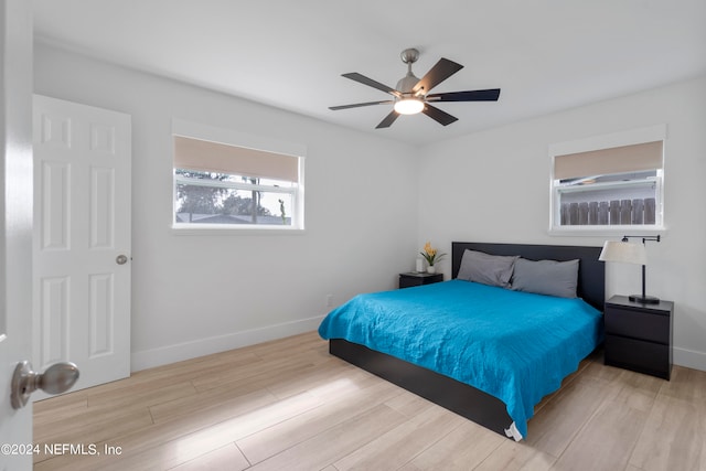 bedroom with ceiling fan and light hardwood / wood-style flooring