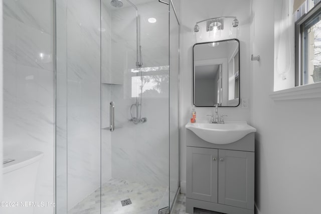 full bathroom with a marble finish shower, toilet, and vanity