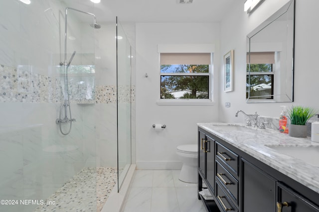 bathroom with tile patterned flooring, toilet, tiled shower, and vanity