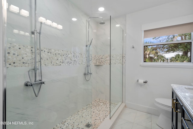 bathroom with toilet, tile patterned flooring, a tile shower, and vanity