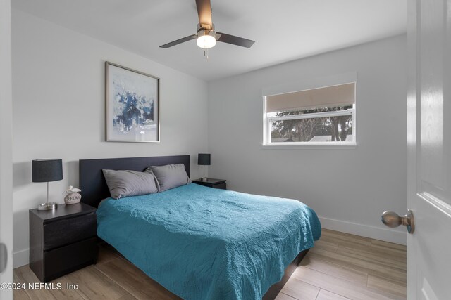 bedroom with light hardwood / wood-style flooring and ceiling fan