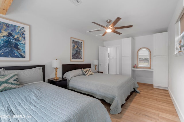 bedroom with ceiling fan and light hardwood / wood-style flooring