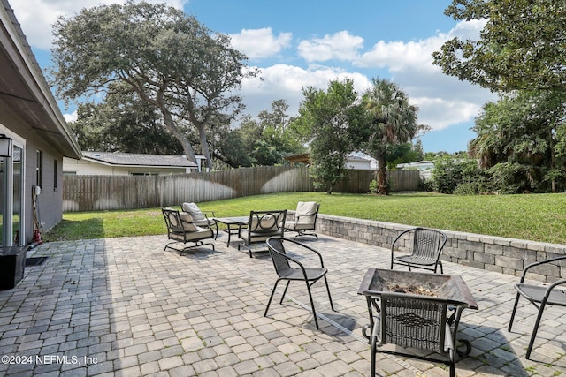 view of patio featuring a fenced backyard and an outdoor fire pit