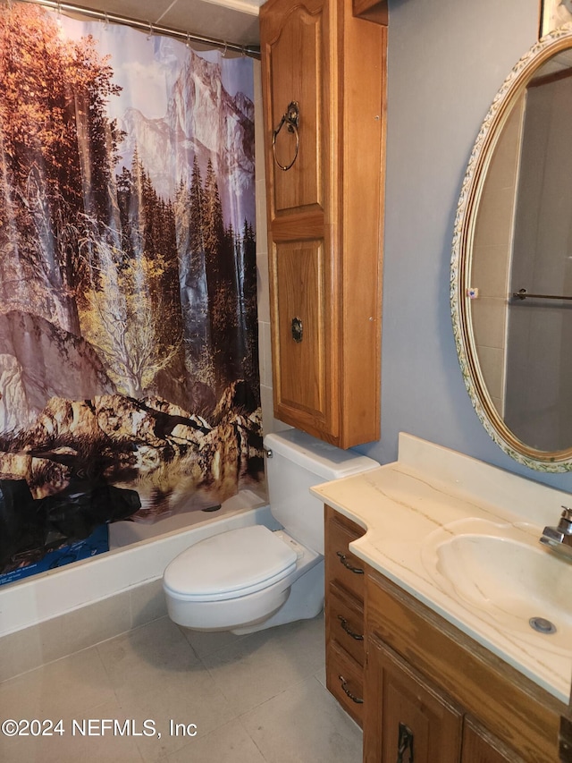 bathroom with vanity, toilet, and tile patterned floors