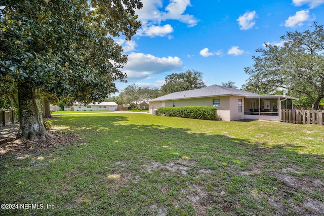 view of yard with a sunroom