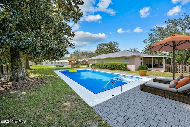 view of pool featuring a sunroom, a yard, and a patio