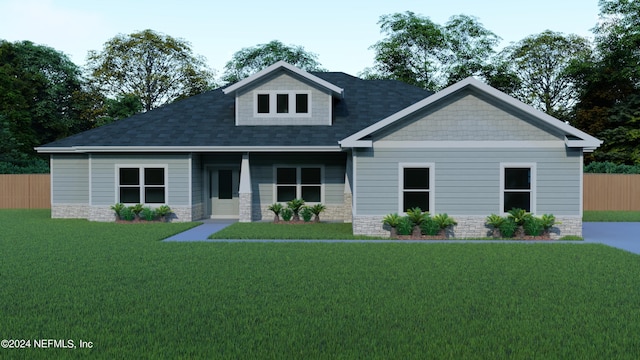 craftsman inspired home with a front lawn