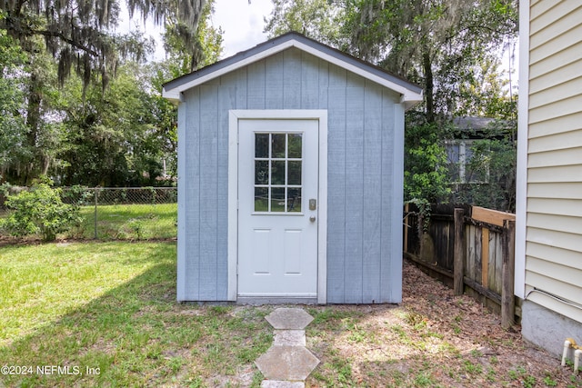 view of outbuilding with a yard