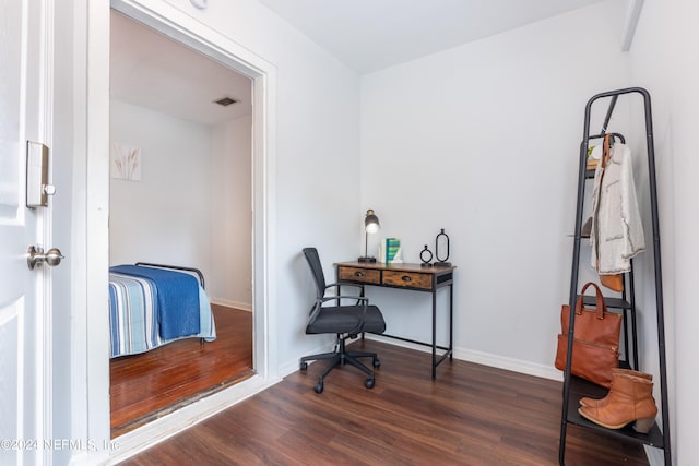 office with dark hardwood / wood-style floors