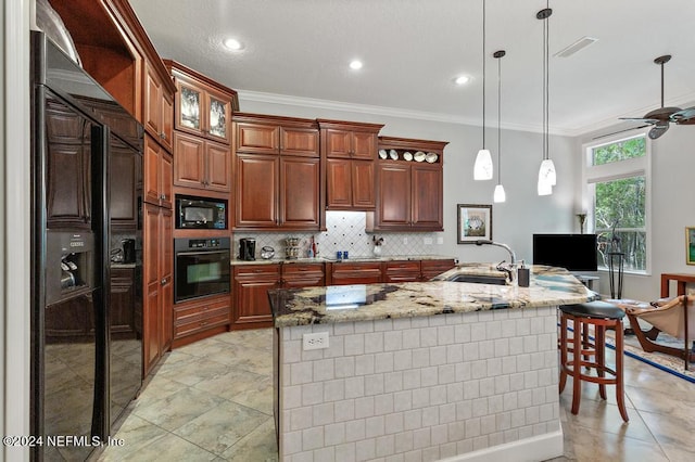 kitchen with crown molding, decorative backsplash, hanging light fixtures, black appliances, and a sink