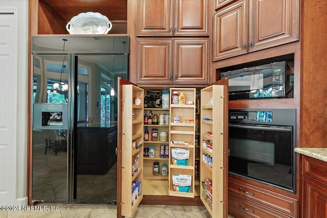 kitchen featuring black appliances, light stone counters, and open shelves