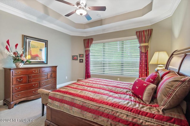 bedroom featuring a ceiling fan, a raised ceiling, light colored carpet, and baseboards