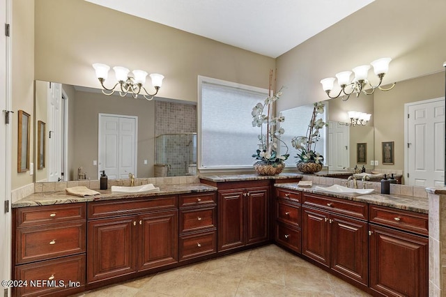 bathroom featuring a chandelier, a shower stall, tile patterned floors, and vanity